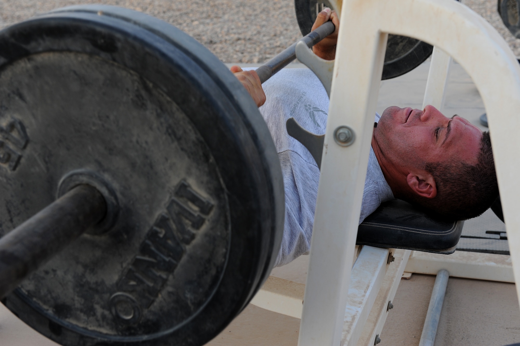 Staff Sgt. Joe Cardiel, 52nd Expeditionary Flying training Squadron, Camp Speicher, Iraq, works out at the "prison yard" after a day at work. The NCO is an aircrew flight equipment specialist, deployed from El Paso, Texas. He is responsible for training Iraqi air force AFE specialists. He is deployed from the 2nd Operations Support Squadron at Barksdale Air Force Base, La. (U.S. Air Force photo/Staff Sgt. Mike Meares)