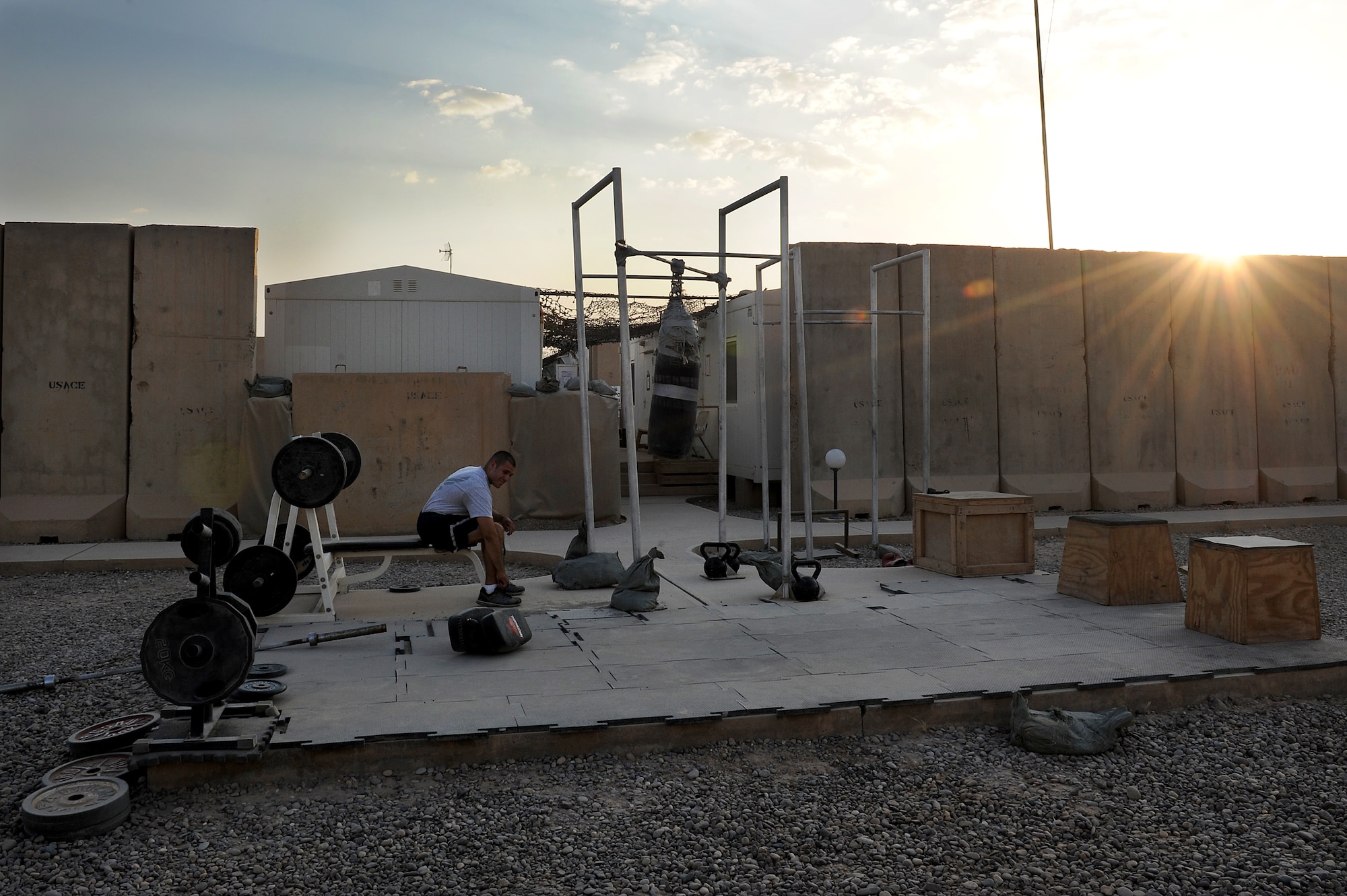 Staff Sgt. Joe Cardiel, 52nd Expeditionary Flying training Squadron, Camp Speicher, Iraq, works out at the "prison yard" after a day at work. The NCO is an aircrew flight equipment specialist, deployed from El Paso, Texas. He is responsible for training Iraqi air force AFE specialists. He is deployed from the 2nd Operations Support Squadron at Barksdale Air Force Base, La. (U.S. Air Force photo/Staff Sgt. Mike Meares)