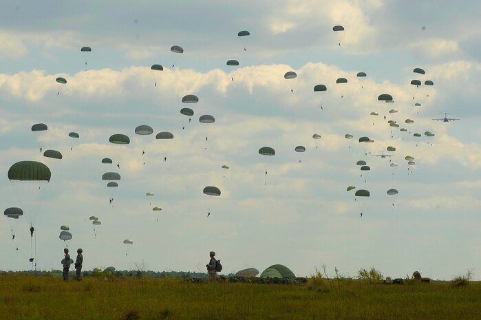 U.S. Army paratroopers from the 82nd Airborne Division descend to the ground after jumping out of a C-17 Globemaster III aircraft, over drop zone Sicily during Joint Operations Access Exercise (JOAX) at Ft. Bragg, N.C., on Sept. 10, 2011.  JOAX is a one-week exercise to prepare the Air Force and the Army to respond to worldwide crises and contingencies.  U.S. Air Force photo/A1C James Richardson 