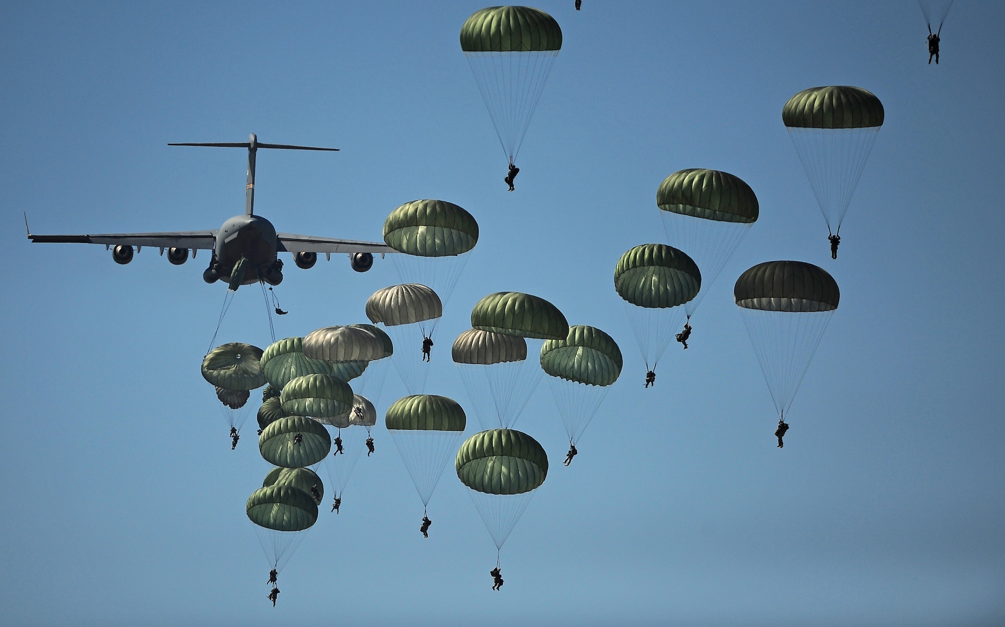 U.S. Army paratroopers from the 82nd Airborne Division descend to the ground after jumping out of a C-17 Globemaster III aircraft, over drop zone Sicily during Joint Operations Access Exercise (JOAX) at Ft. Bragg, N.C., on Sept. 10, 2011.  JOAX is a one-week exercise to prepare the Air Force and the Army to respond to worldwide crises and contingencies.  U.S. Air Force photo/A1C James Richardson 