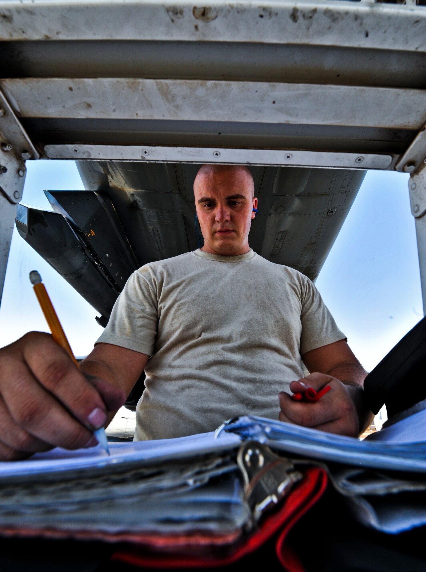 SOUTHWEST ASIA -- Staff Sgt. Carter Norrie, 34th Aircraft Maintenance Unit weapons load team chief, completes a post munitions load checklist, Sept. 14, 2011, at an undisclosed location in Southwest Asia. Norrie, a native of Kenmare, N.D., is deployed from Ellsworth Air Force Base, S.D. (U.S. Air Force photo/Senior Airman Paul Labbe)