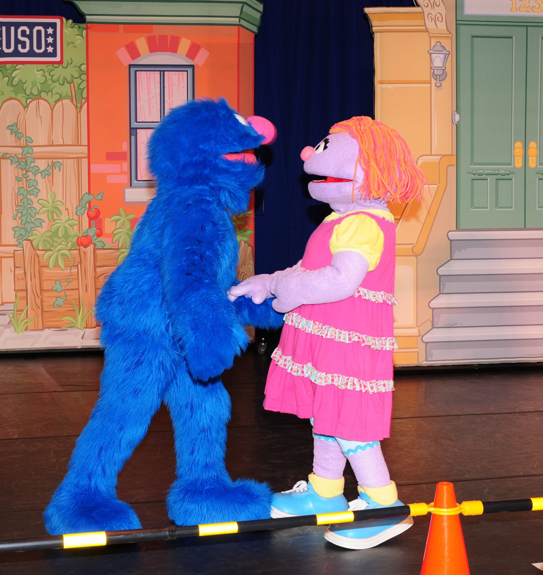 RAF MILDENHALL, England -- Grover and Katie, two of the five Sesame Street characters who visited th North Side Fitness Center Sept. 15, 2011, as part of the Sesame Street/United Services Organization Experience for Military Families, talk about Katie and her parents having to move to another base. Katie was sad because she would be leaving behind all her friends, but Grover, Elmo, Rosita, Cookie Monster and Honker taught her that change can be good, and that she would make new friends. (U.S. Air Force photo by Karen Abeyasekere)