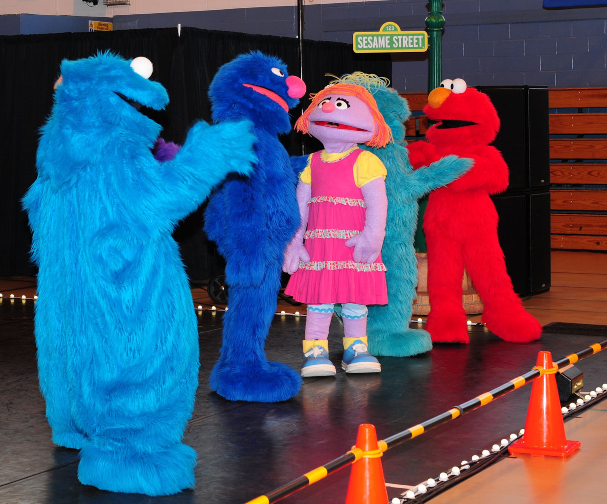 RAF MILDENHALL, England -- Cookie Monster, Grover, Katie, Rosita and Elmo sing and dance for the audience at the Sesame Street/United Services Organization Experience for Military Families at the North Side Fitness Center, Sept. 15, 2011. The Sesame Street characters gave two performances, to a crowd totalling more than 1,000. (U.S. Air Force photo/Karen Abeyasekere)