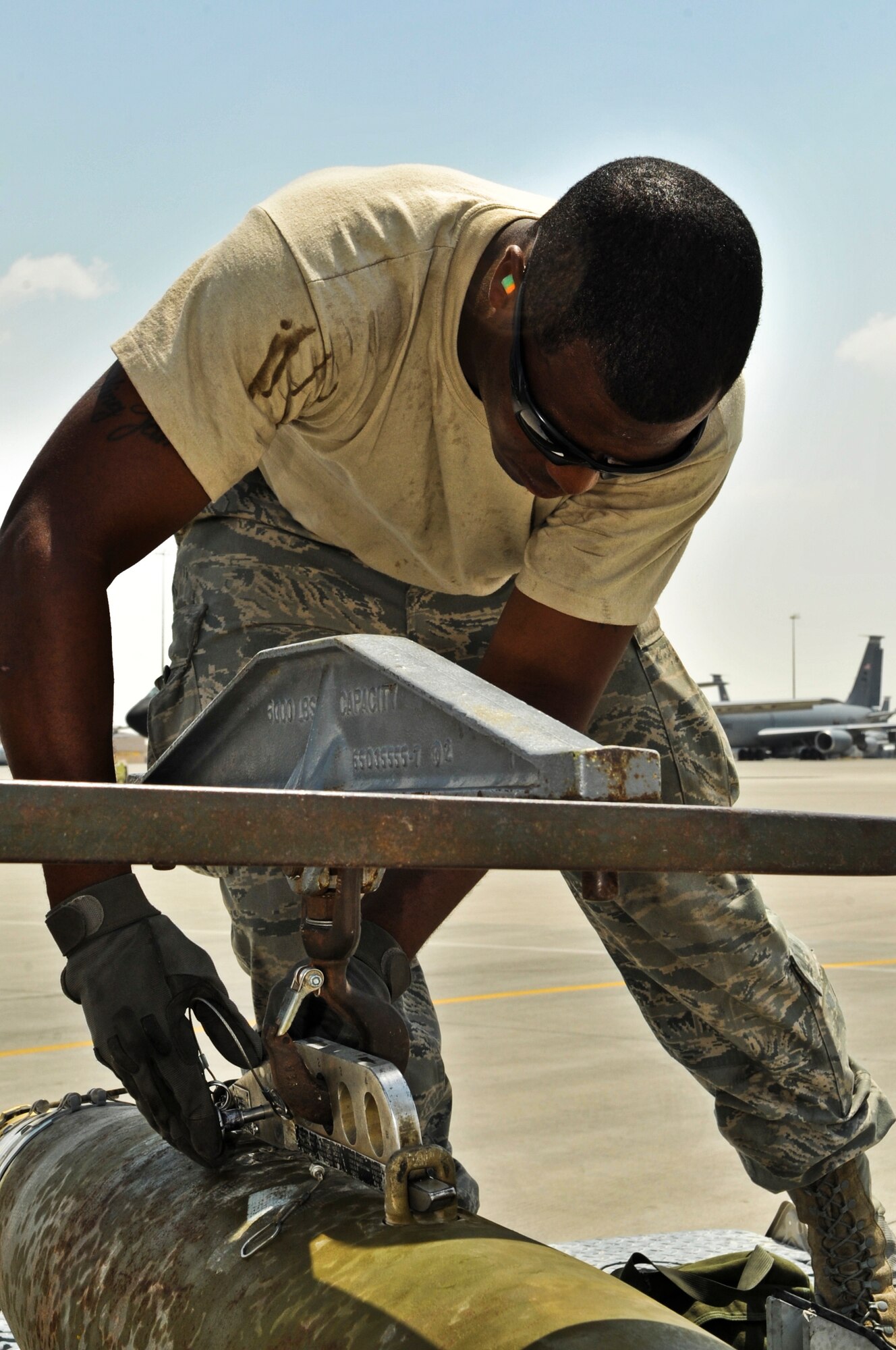 SOUTHWEST ASIA -- Airman 1st Class James Taylor, 37th Aircraft Maintenance Unit weapons load team member, secures a munition to an MJ-1 lift truck, better known as a jammer, Sept. 14, 2011, at an undisclosed location in Southwest Asia. Taylor, a native of Killeen, Texas, is deployed from Ellsworth Air Force Base, S. D. (U.S. Air Force photo/Senior Airman Paul Labbe)