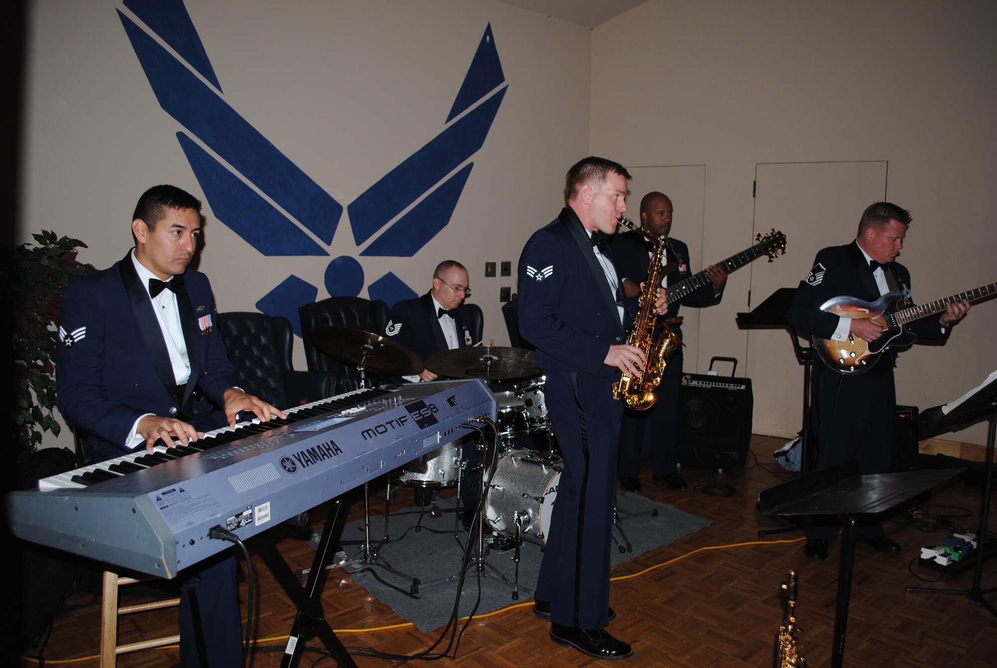 The Warhawk  Band performs another jazz hit during the 433rd Airlift Wing 60th Anniversary Dinner, held Sept. 10, 2010, at the Gateway Club Ballroom at Lackland Air Force Base, Texas. (U.S. Air Force photo/Senior Airman Luis Loza Gutierrez)