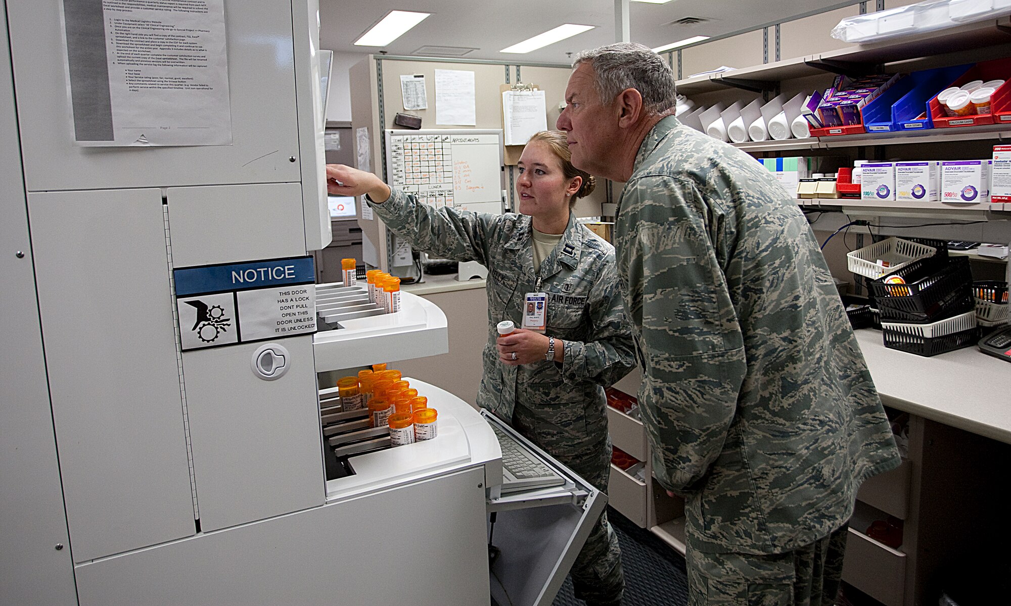 Capt. Sarah Kelly, 90th Medical Support Squadron, demonstrates the system for filling prescriptions during the 20th Air Force commander’s visit here Sept. 7. While here, Maj. Gen. C. Donald Alston visited units within the 90th Medical Group and 90th Mission Support Group as part of a wing familiarization tour. (U.S. Air Force photo by Matt Bilden)