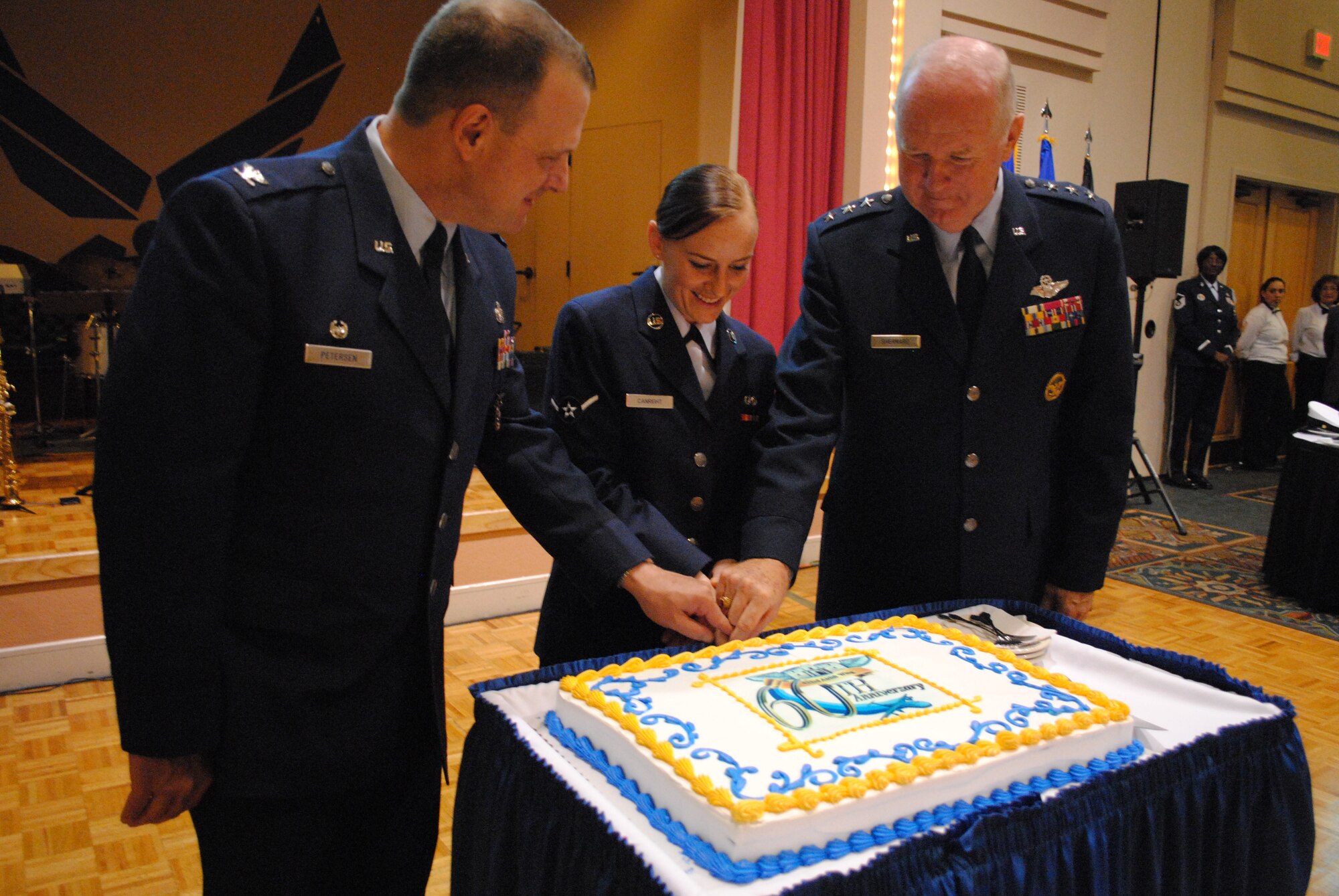 The Alamo Wing celebratory dinner comes to a close as Airman Crystal Canright, the most junior enlisted service member attending the dinner, joined Col. Craig Petersen, 433rd Mission Support Group commander and retired Lt. Gen. James E. Sherrard III, for the official cutting of the 433rd Airlift Wing 60th Anniversary cake. Gen. Sherrard was the official guest speaker at the dinner which took place Sept. 10, 2011, at the Gateway Club at Lackland Air Force Base, Texas, and Col. Petersen was the official host. (U.S. Air Force photo/Senior Airman Luis Loza Gutierrez)