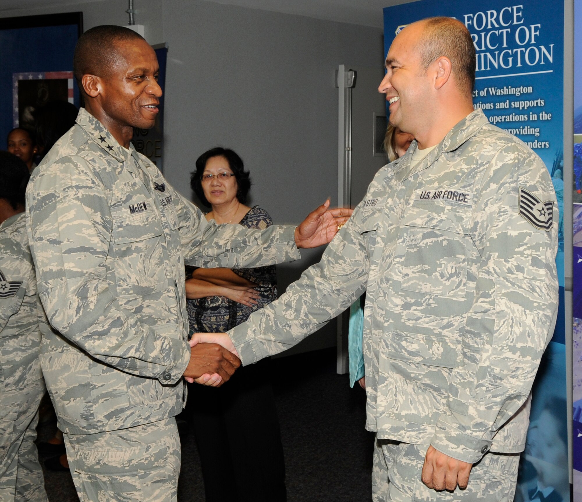 Maj. Gen. Darren W. McDew, commander of Air Force District of Washington, greets Technical Sgt. Oscar Castro, AFDW unit training manager, at the cake and ice cream social held in celebration of the Air Force Birthday Sept. 15 on Joint Base Andrews, Md. The Air Force celebrates it's 64th birthday on Sept. 18. (U.S. Air Force photo by Staff Sgt. Christopher Ruano)