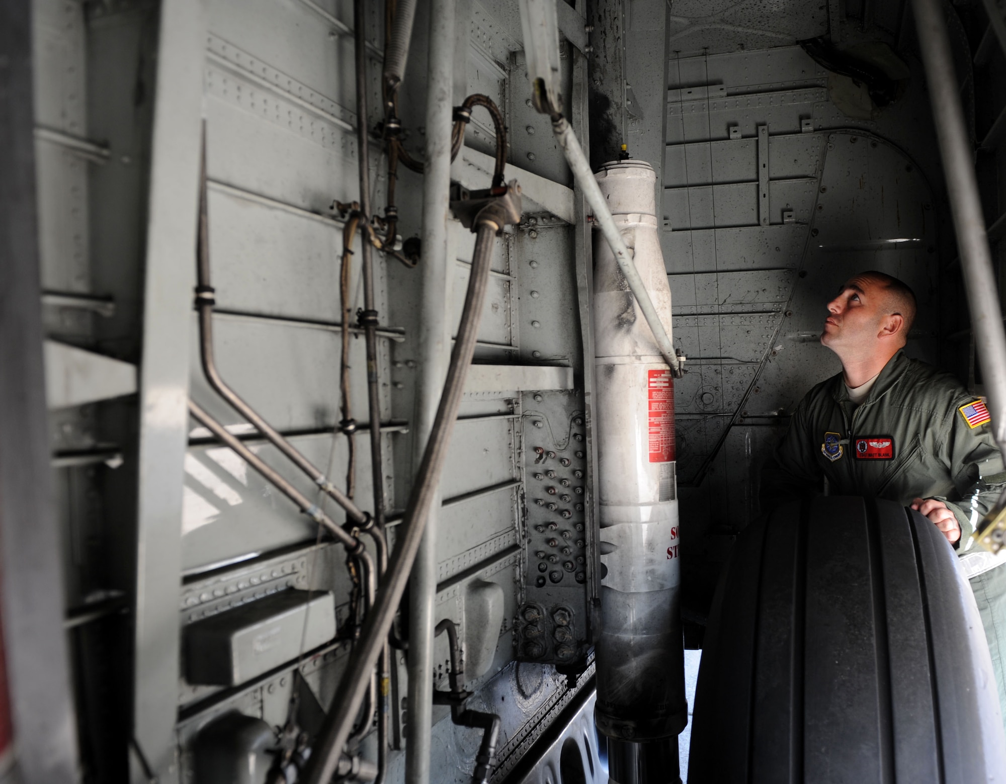 Tech. Sgt. Matthew Blank, a 50th Airlift Squadron evaluator flight engineer, inspects landing gear components on a C-130E, Sept. 15, 2011, at Little Rock Air Force Base, Ark. Blank, a Scottsdale, Ariz., native, was awarded 50 AS Instructor of the year for 2010 for his outstanding instructor and leadership abilities. (U.S. Air Force Photo by Senior Airman Caleb Pierce) 