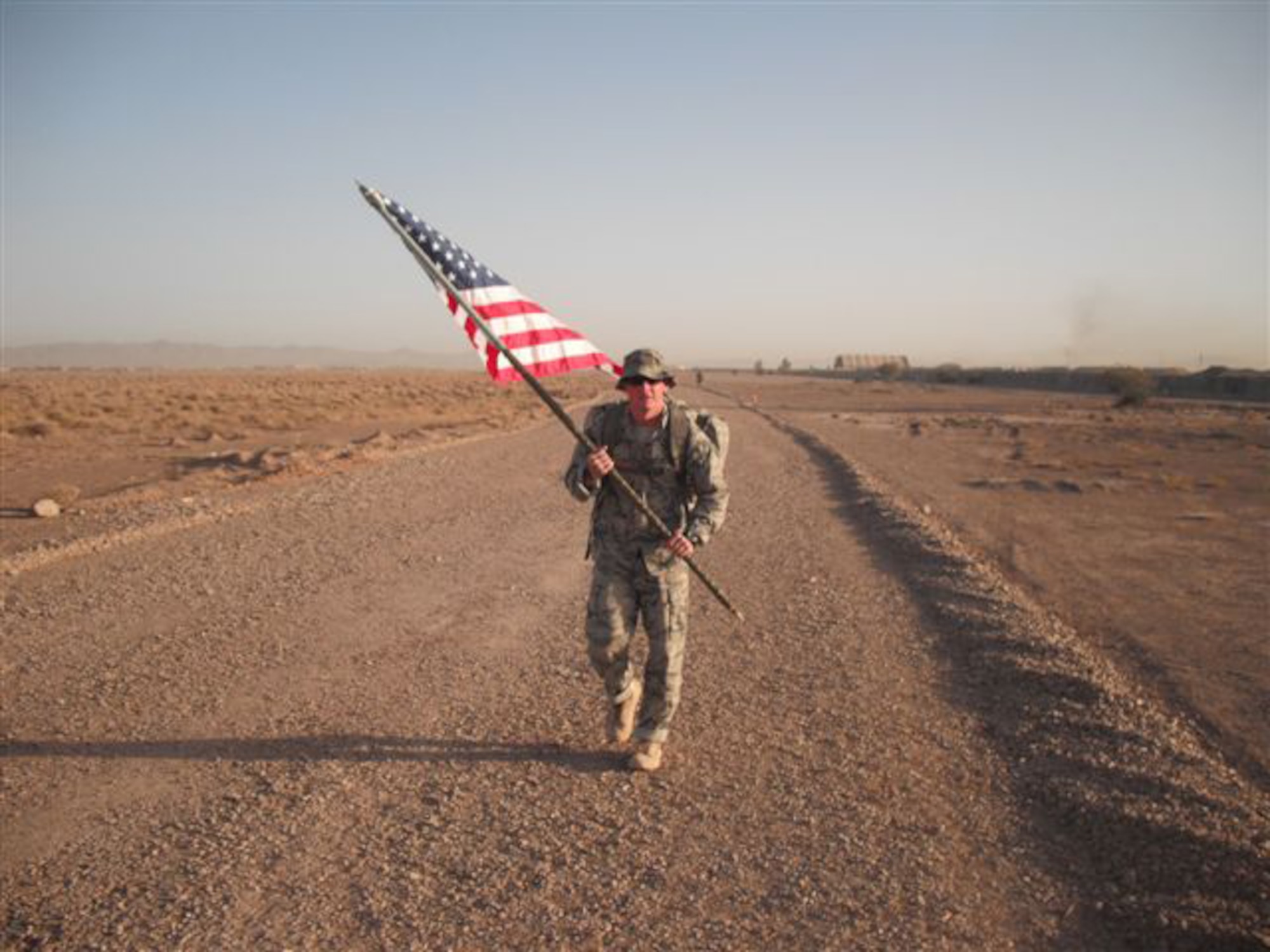 U.S. Air Force Security Forces, Master Sgt. Jason Brown, marches with the American Flag at Shindand Air Base, Shindand, Afghanistan September 11, 2011. Airmen from the 838th Air Expeditionary Advisory Group, participated in a 24-hour ruck march in honor of the victims of the September 11, 2001 attacks.  (U.S. Air Force photo by 2nd Lt. Jason Sawyers)