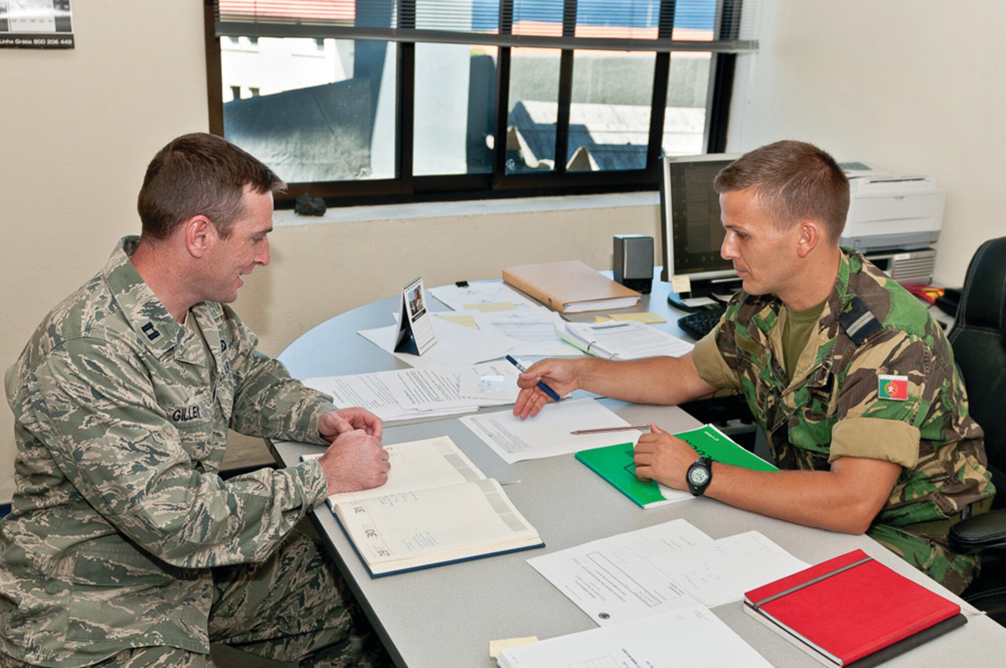 Capt. Jesse Gilley, LEAP participant, and Lt. Pedro Resendes, acting commander,
AB4 Security Forces, converse in Portuguese. Captain Gilley was shadowing
Lieutenant Resendes and participating in AB4 Security Forces' daily operations
in order to improve his language proficiency in Portuguese. LEAP is a program
designed to give Air Force officers the opportunity to go to the field where they can
further develop language skills and learn about the culture and people in their area
of language specialty. (Photo by Lucas Silva).