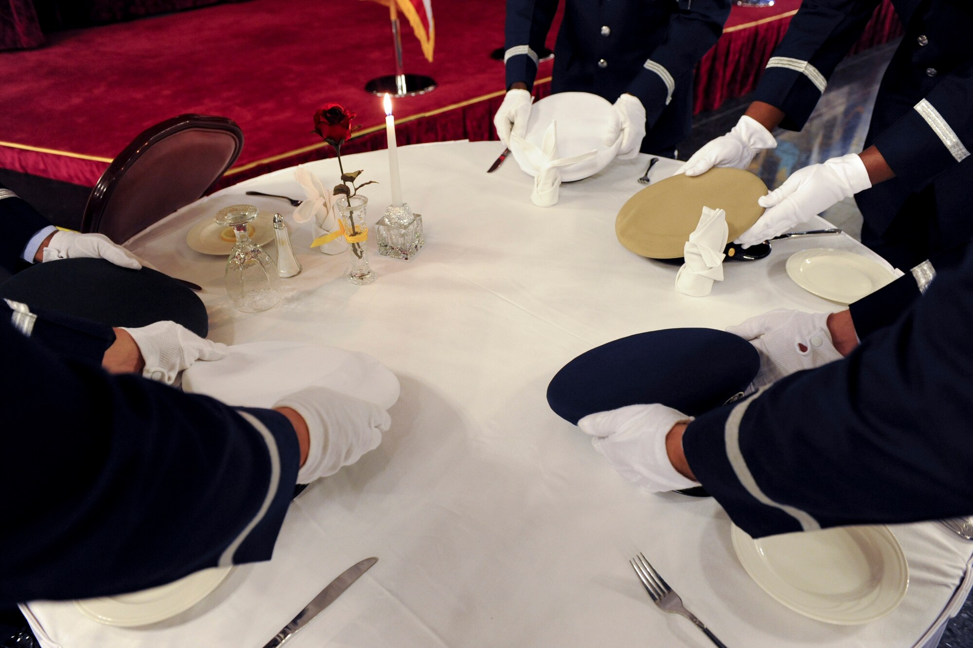 Members of the Kadena Air Base Honor Guard place five hats on an empty table to represent the service members that have yet to return to their friends and family during Kadena's POW/MIA ceremony Sept. 16, 2011. The national POW/MIA recognition day is observed on the third Friday of September every year, but it is important to always remember the sacrifice of prisoners of war and those missing in action. (U.S. Air Force photo by Airman 1st Class Brooke P. Beers)     