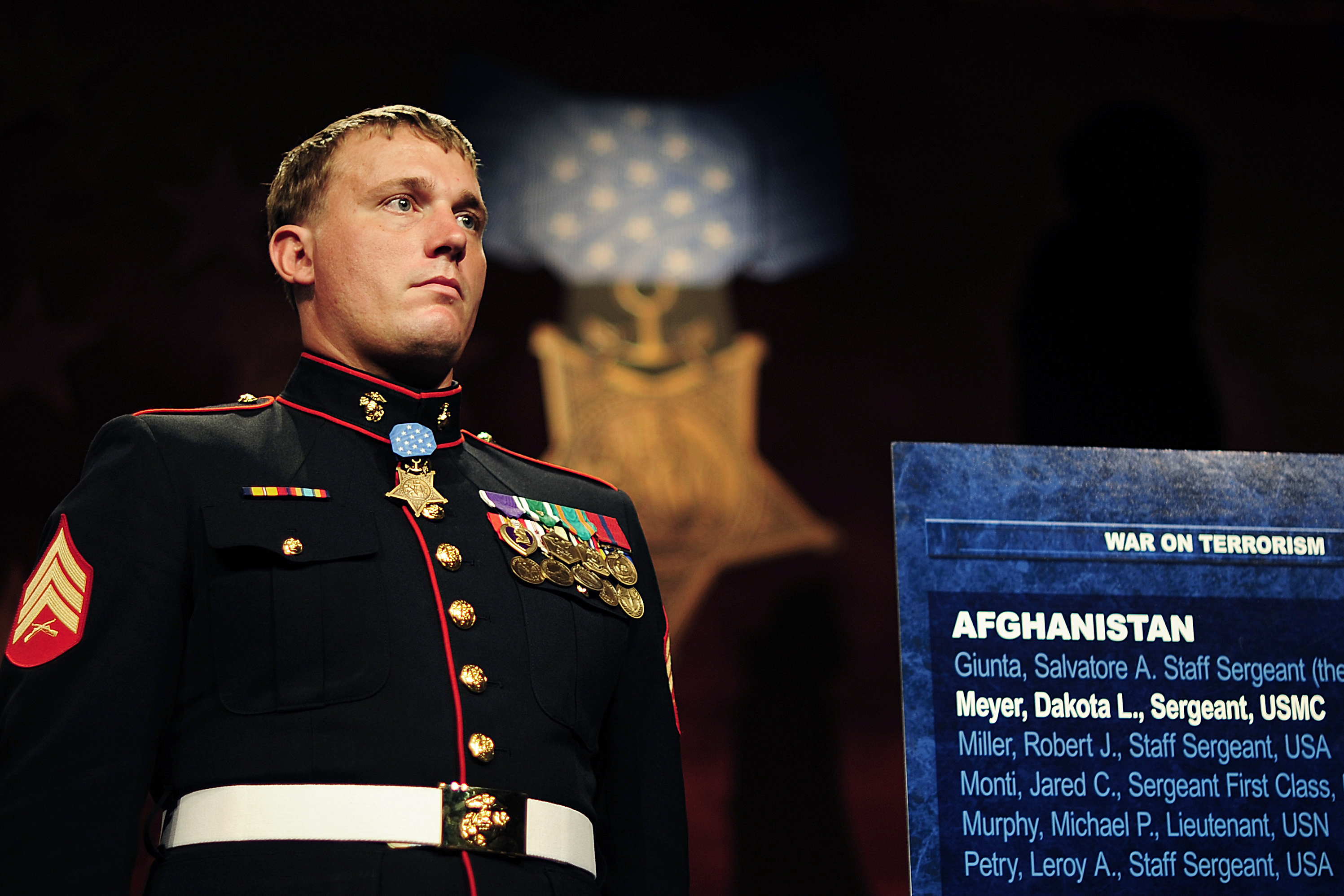 Medal Of Honor Recipient Marine Corps Sgt Dakota L Meyer Stands Next To A Plaque Bearing