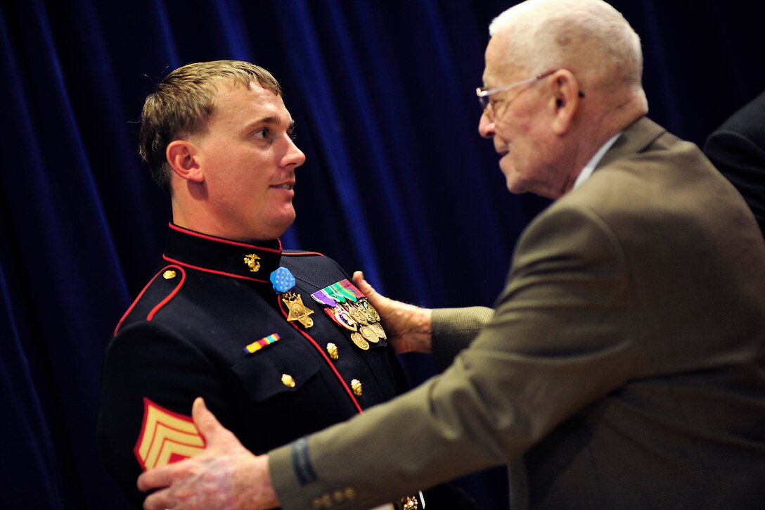 Dwight Meyer, right, a former Marine who served during the Korean War, congratulates his grandson, Medal of Honor recipient Marine Corps Sgt. Dakota L. Meyer, after he was inducted into the Hall of Heroes at the Pentagon, Sept. 16, 2011.