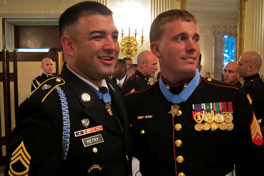 Medal of Honor recipients Army Sgt. 1st Class Leroy Arthur Petry, left, and Marine Corps Sgt. Dakota Meyer, right, stand side-by-side after Meyer recieved his medal from President Barack Obama during the Medal of Honor ceremony in the East Room of the White House, Washington, D.C., Sept. 15, 2011.