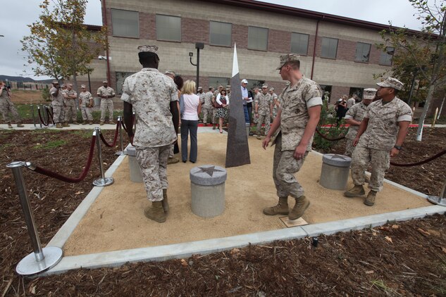 Marines and Sailors with 1st Marine Special Operations Battalion, U.S. Marine Corps Forces, Special Operations Command, observe a new memorial honoring 1st MSOB's fallen warriors at a memorial dedication ceremony aboard Camp Pendleton, Calif. Sept. 16. September was a month of rememberance and reflection, marked by several ceremonies taking place throughout MARSOC to honor its fallen servicemembers and the victims of 9/11.