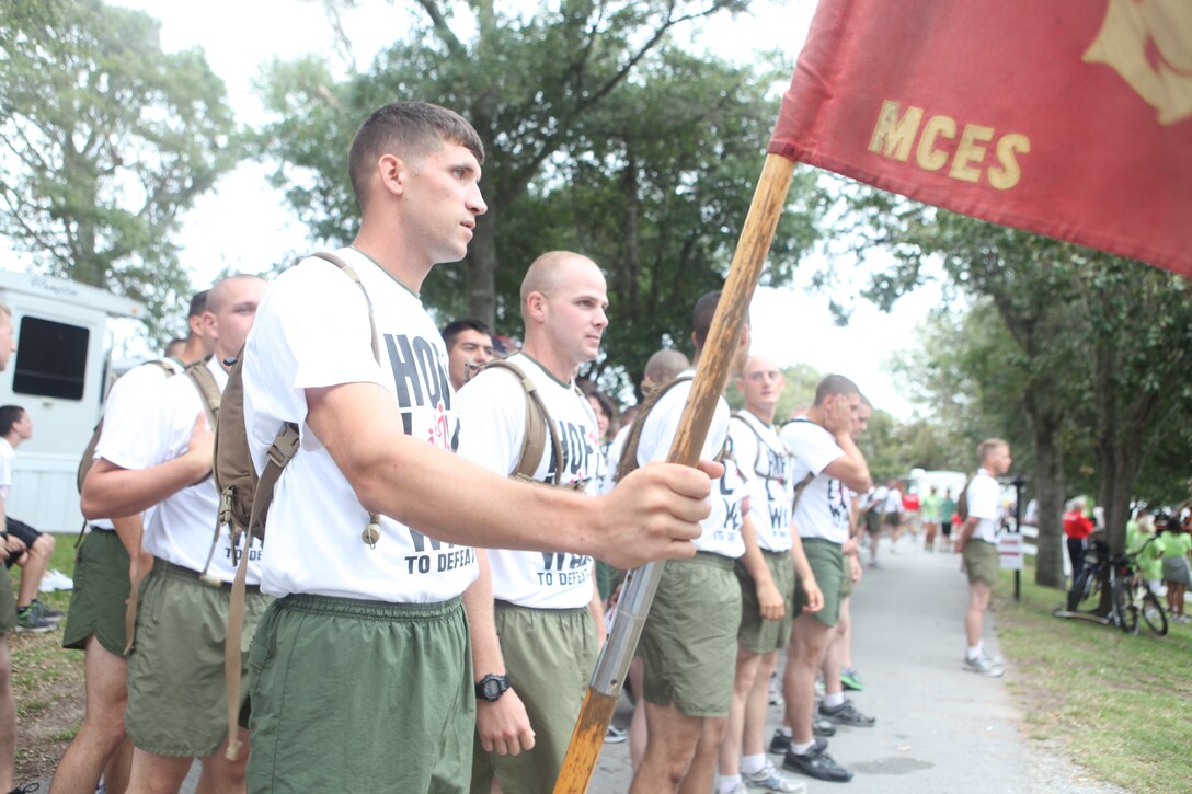 Marines from Marine Corps Engineer Center stand in formation as they await the start of the Walk to Defeat ALS in Emerald Isle, N.C., Sept. 17. The walk has raised nearly $500,000 for ALS research since it began in 2003.