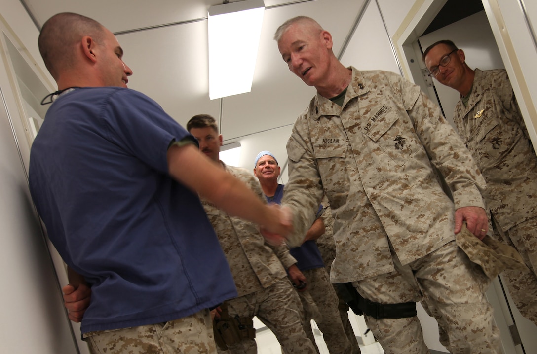 Maj. Gen. John A. Toolan, commanding general of Regional Command Southwest, meets with sailors from Alpha Surgical Company, 2nd Marine Logistics Group (Forward), at the dental clinic aboard Camp Leatherneck, Afghanistan, Sept. 17.Toolan toured several facilities operated by 2nd MLG (FWD) personnel to include the post office and Concussion Restoration Care Center. (U.S. Marine Corps photo by Sgt. Justin J. Shemanski)