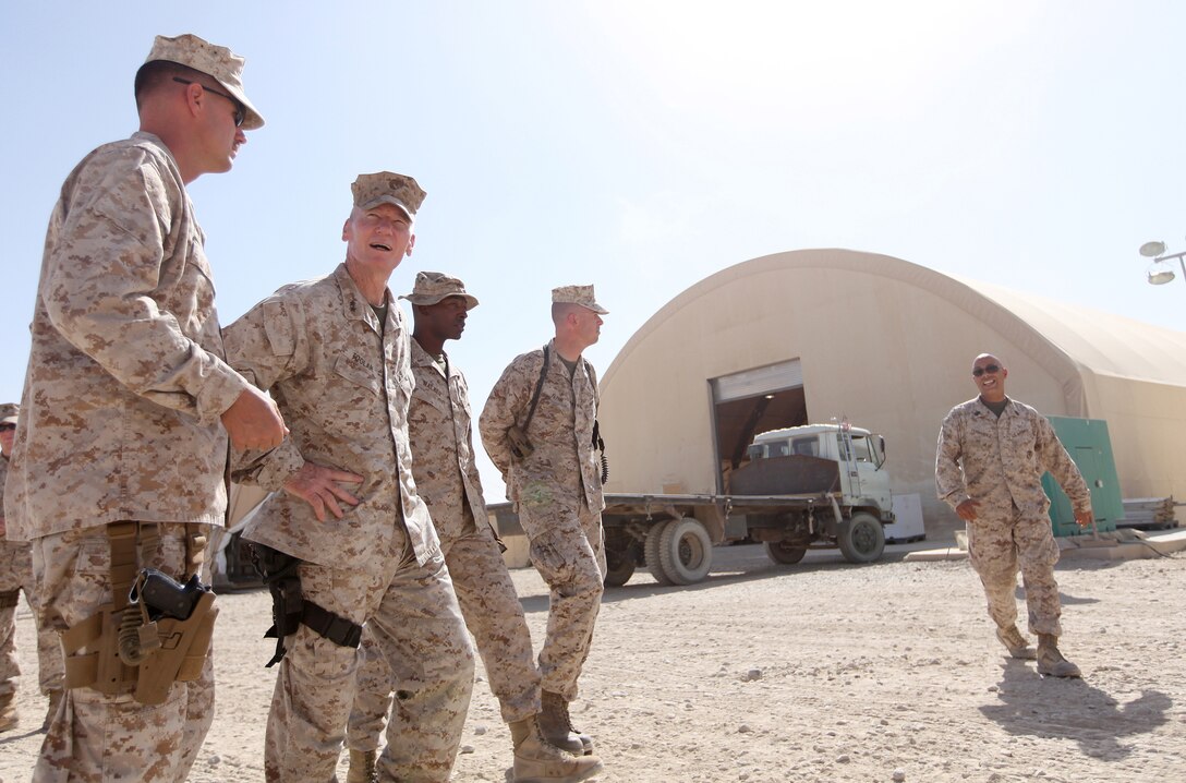 Maj. Gen. John A. Toolan (second from left), commanding general of Regional Command Southwest, is accompanied by 2nd Marine Logistics Group (Forward) personnel as they tour the grounds of the Camp Leatherneck Post Office, Sept. 17. Postal Marines presented Toolan with an all-access look at their daily operations. (U.S. Marine Corps photo by Sgt. Justin J. Shemanski)