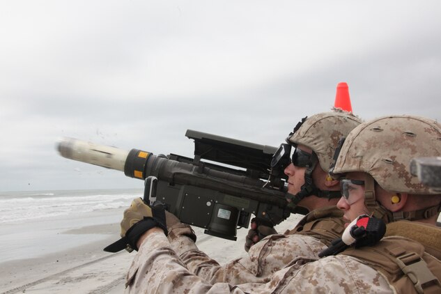A Stinger Missile explodes out of the end of the PL-87 Stinger Missile launcher causing glass to shatter as a Marine with 2nd Low Altitude Air Defense Battalion fires at an unmanned aerial target on Onslow Beach aboard Marine Corps Base Camp Lejeune, N.C., during 2nd LAAD's live Stinger Missile shoot Sept. 17.
