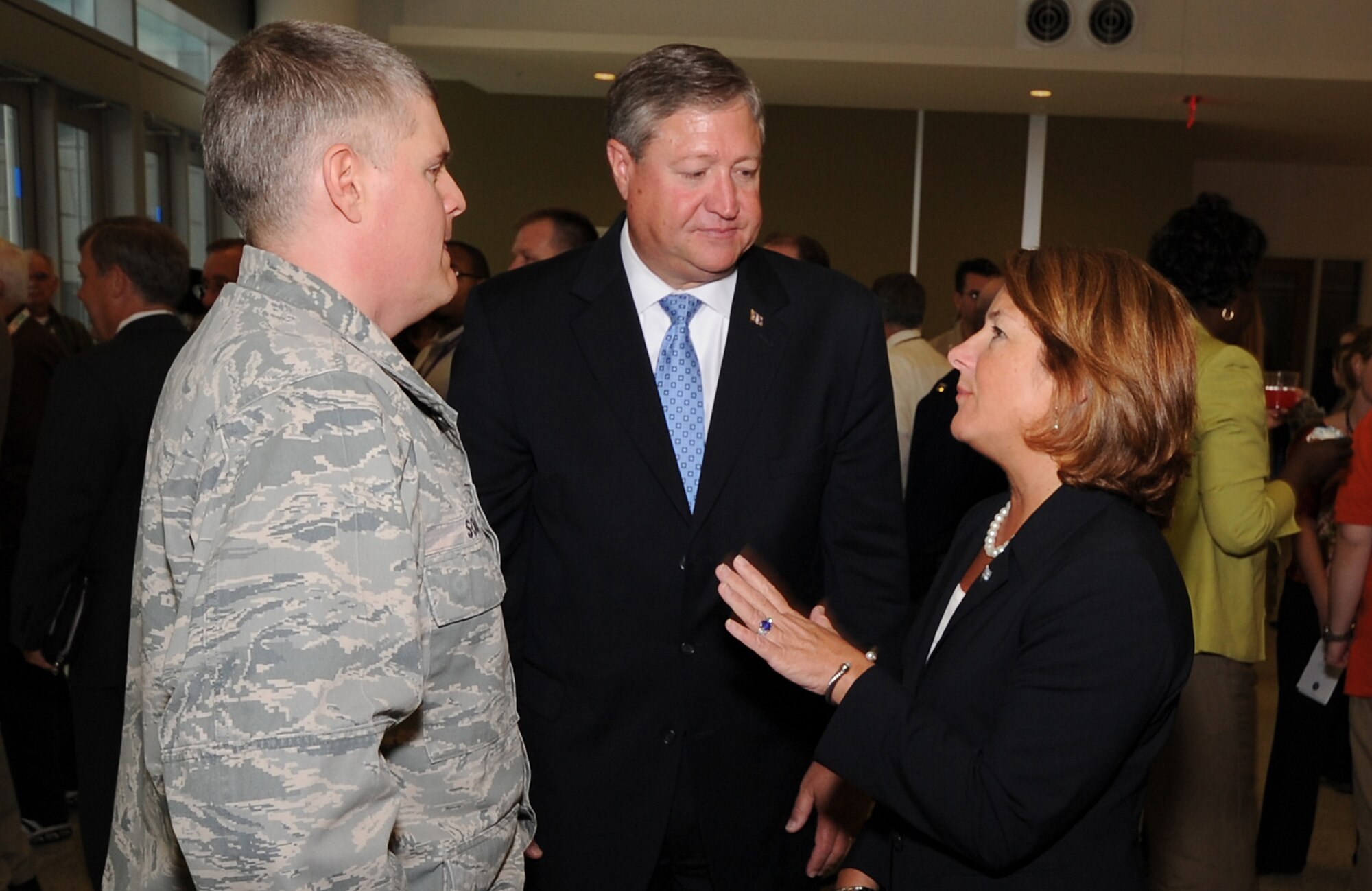 Secretary of the Air Force Michael Donley and Letitia A. Long speak to Col. Craig Souza Sept. 16, 2011, during a ceremony that celebrated the Air Force's 64th birthday. Long is the director of the National Geospatial-Intelligence Agency, and Souza is one of the agency’s wounded warriors who was recognized during the birthday ceremony. (National Geospatial-Intelligence Agency photo/Anthony Boone)