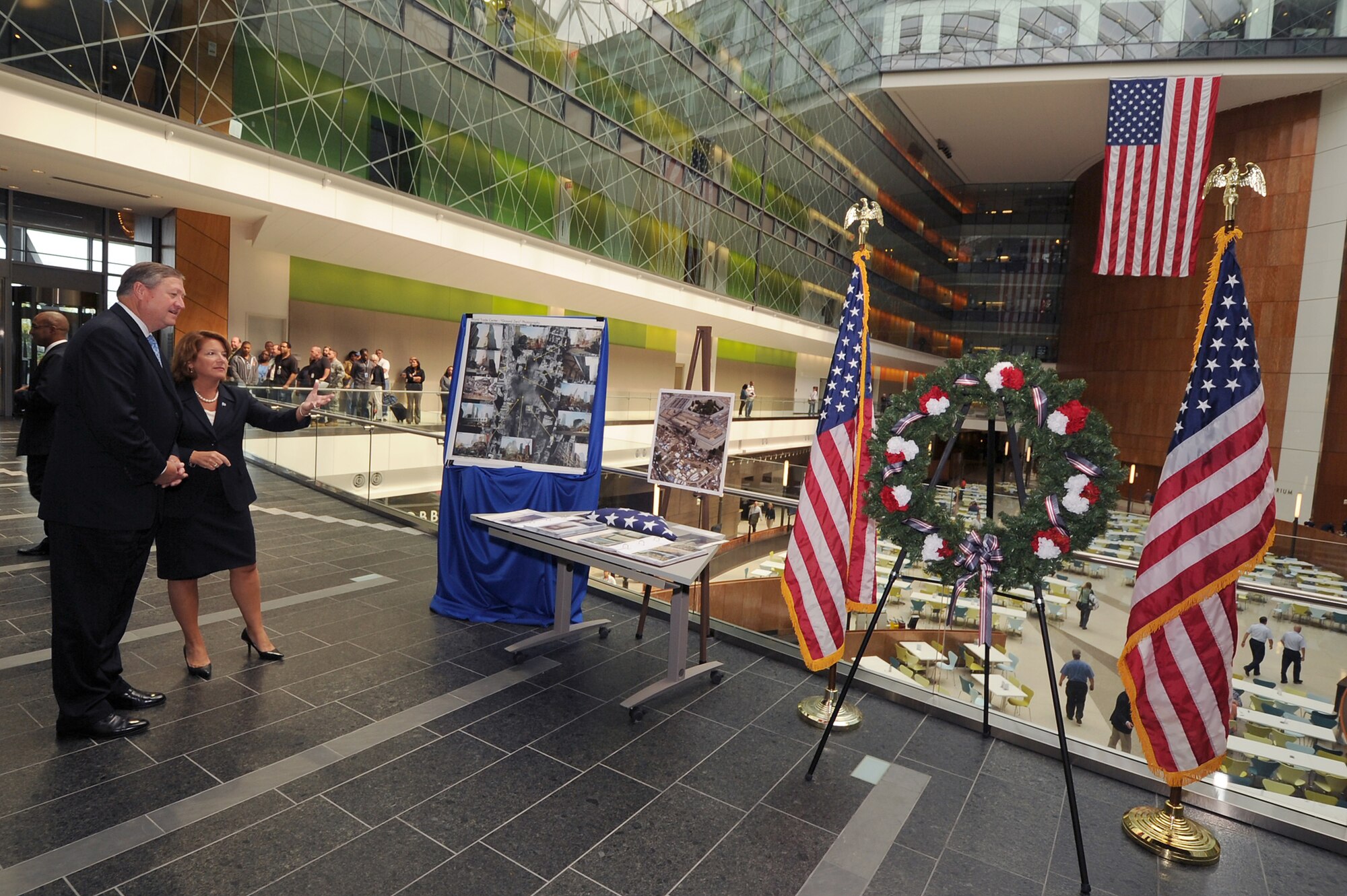 Letitia A. Long shows Secretary of the Air Force Michael Donley a tribute to 9/11 in the atrium of National Geospatial-Intelligence Agency’s headquarters Sept. 16, 2011, in Springfield, Va. Long is the , NGA director. (National Geospatial-Intelligence Agency photo/Anthony Boone)