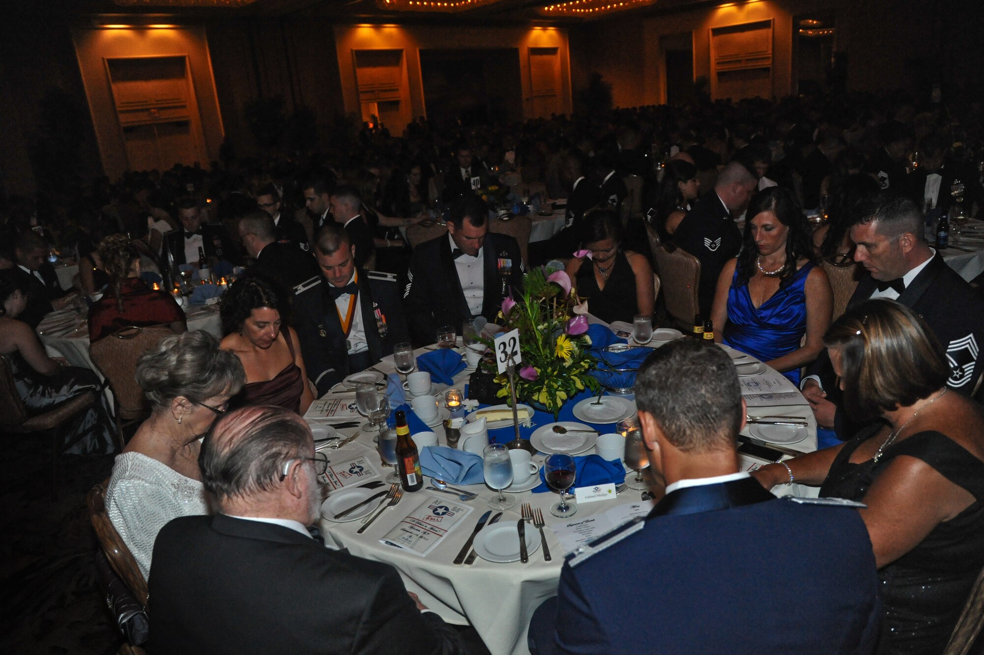 Airmen and guests bow their heads in prayer at the 64th annual Air Force Ball, held at the Hilton Hawaiian Village in Waikiki, Sept. 16. The ball celebrated the Air Force's 64th year as a seperate service and paid tribute to the Airmen who have served throughout its history. (U.S. Air Force photo/Senior Airman Lauren Main)
