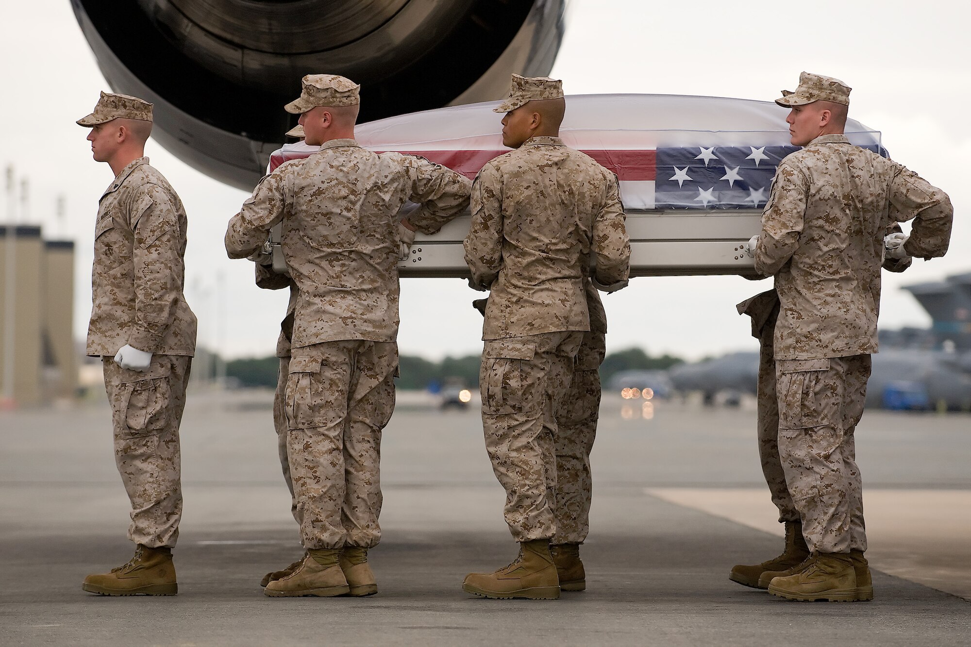 A U.S. Marine Corps carry team transfers the remains of Marine Cpl. Michael J. Dutcher , of Asheville, N.C., at Dover Air Force Base, Del., Sept. 17, 2011. Dutcher was assigned to the 1st Battalion, 5th Marine Regiment, 1st Marine Division, I Marine Expeditionary Force, Camp Pendleton, Calif. (U.S. Air Force photo/Steve Kotecki)
