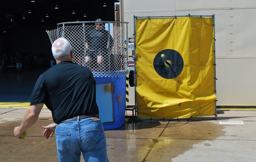 A members of the 507th Air Refueling Wing takes a shot at dunking a fellow member at the festivities during the 2011 507th ARW Family Day. Activities included drawings for prizes, music and inflatable moon walks and face painting for the kids.