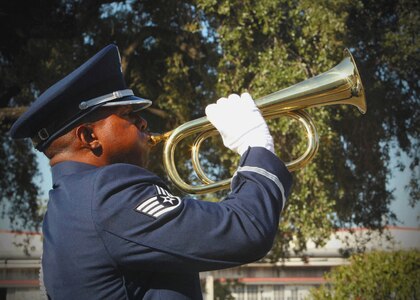 Staff Sgt. Patrick Reese, a member of the Lackland Honor Guard, plays taps at the close of the 9/11 Remembrance Ceremony Sept. 9 at Port San Antonio. Air Force units based at Port San Antonio’s Bldg. 171 marked the 10th anniversary of the 9/11 terrorist attacks on American soil with the ceremony. Reese is assigned to the 342nd Training Squadron. (U.S. Air Force photo/Robbin Cresswell)