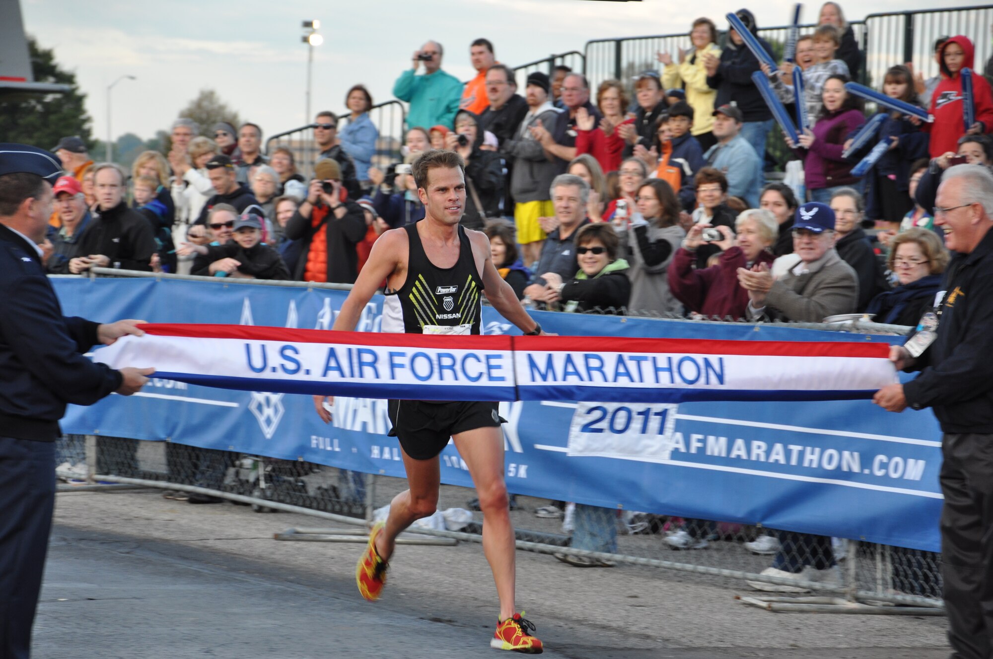 Josh Cox, current course record holder for the full USAF Marathon, finishes first in the 10k race at the 2011 USAF Marathon.  Cox not only finished first, but also set a new course record for the 10k at 31:09.  (US Air Force Photo by Ted Theopolos)