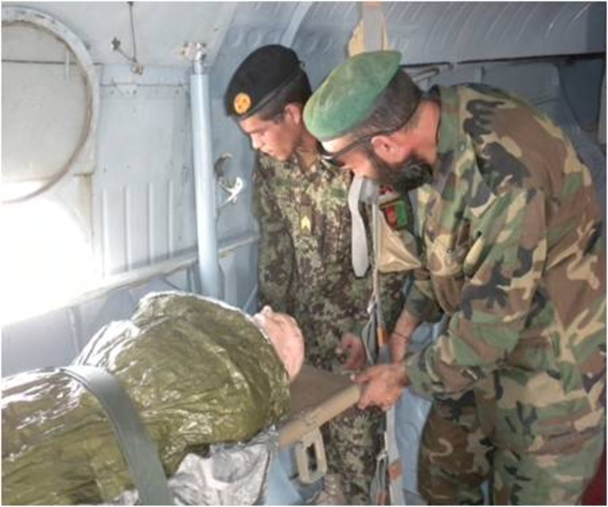 Afghan Air Force medics load a simulated person on an Mi-17 during the basic flight medic course recently. The goal of the 40-hour course was to combine ground and flight medical training to produce a better-rounded medical Afghan Air Force professional. (U.S. Air Force courtesy photo)