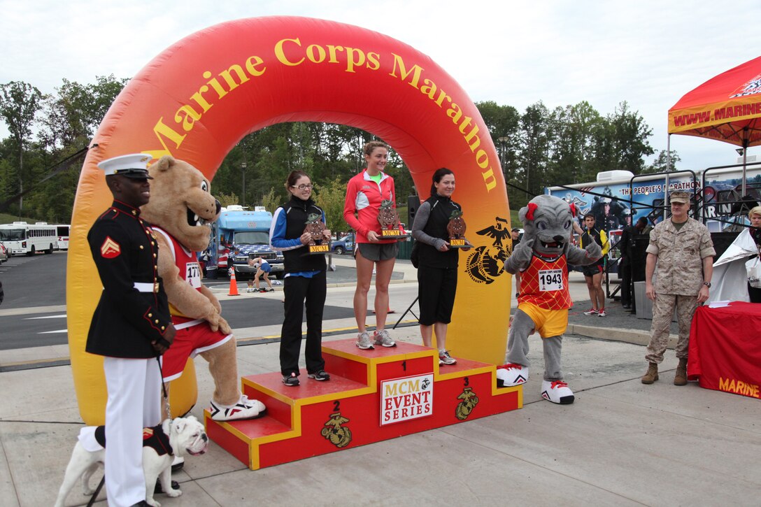 Runners from first to third place, Amanda Roache, Melissa Wisner and Emily Eckman, pose for a winner’s photo after the Marine Corps Marathon Crossroads 17.75k, Sept. 17. Roache, Wisner and Eckman finished with unofficial times of 1:11:31, 1:19:06 and 1:21:04 respectively.