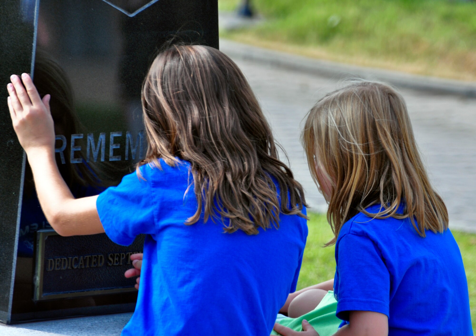 Two children take a moment to look at the POW/MIA Memorial in front of the base theater Sept. 16, 2011. Members of the Osan’s Air Force Sergeants Association honored all POW/MIAs during several ceremonies and events Sept. 12-16. (U.S. Air Force photo/Tech. Sgt. Chad Thompson)