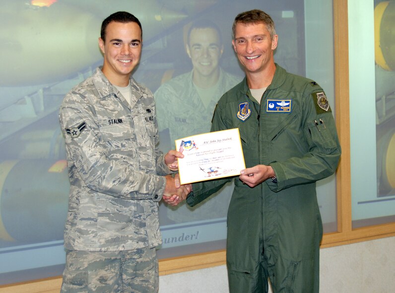 Col. Patrick McKenzie (right), 51st Fighter Wing commander, presents an Airman Spotlight certificate to Airman 1st Class John Stalnik, 51st Munitions Squadron, Sept. 13. (U.S. Air Force photo/Tech Sgt Eric Petosky)