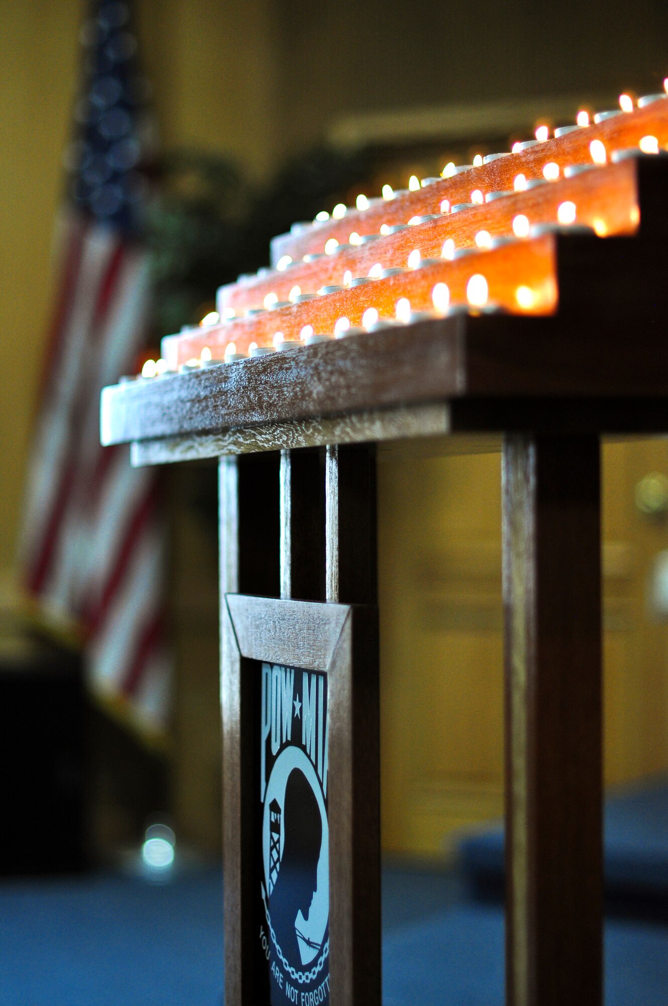 Fifty-two candles, signifying 52 service members who are still missing in action, burn bright during a POW/MIA candlelight vigil ceremony Sept. 14 at the base chapel. Members of the Osan’s Air Force Sergeants Association honored all POW/MIAs during several ceremonies and events Sept. 12-16. (U.S. Air Force photo/Tech. Sgt. Chad Thompson)