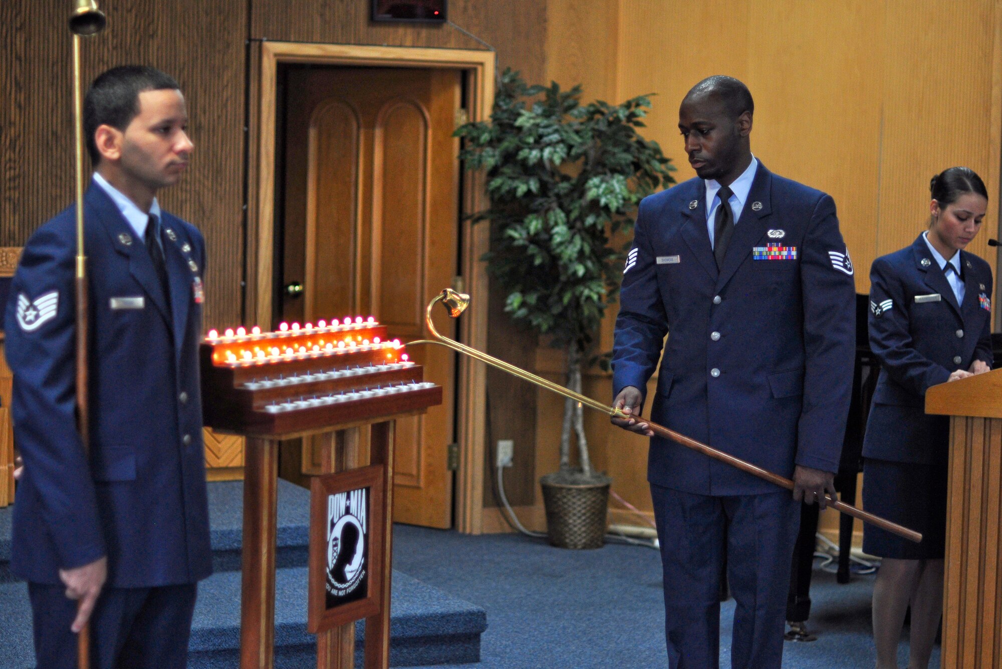 Staff Sgt. Anthony Showers (center), 607th Support Squadron, lights candles as Senior Airman Rocio De La Torre (right), 607th SPTS, reads the names of 52 service members who are still listed as missing in action during a POW/MIA candlelight vigil ceremony Sept. 14 at the base chapel. Members of the Osan’s Air Force Sergeants Association honored all POW/MIAs during several ceremonies and events Sept. 12-16. (U.S. Air Force photo/Tech. Sgt. Chad Thompson)