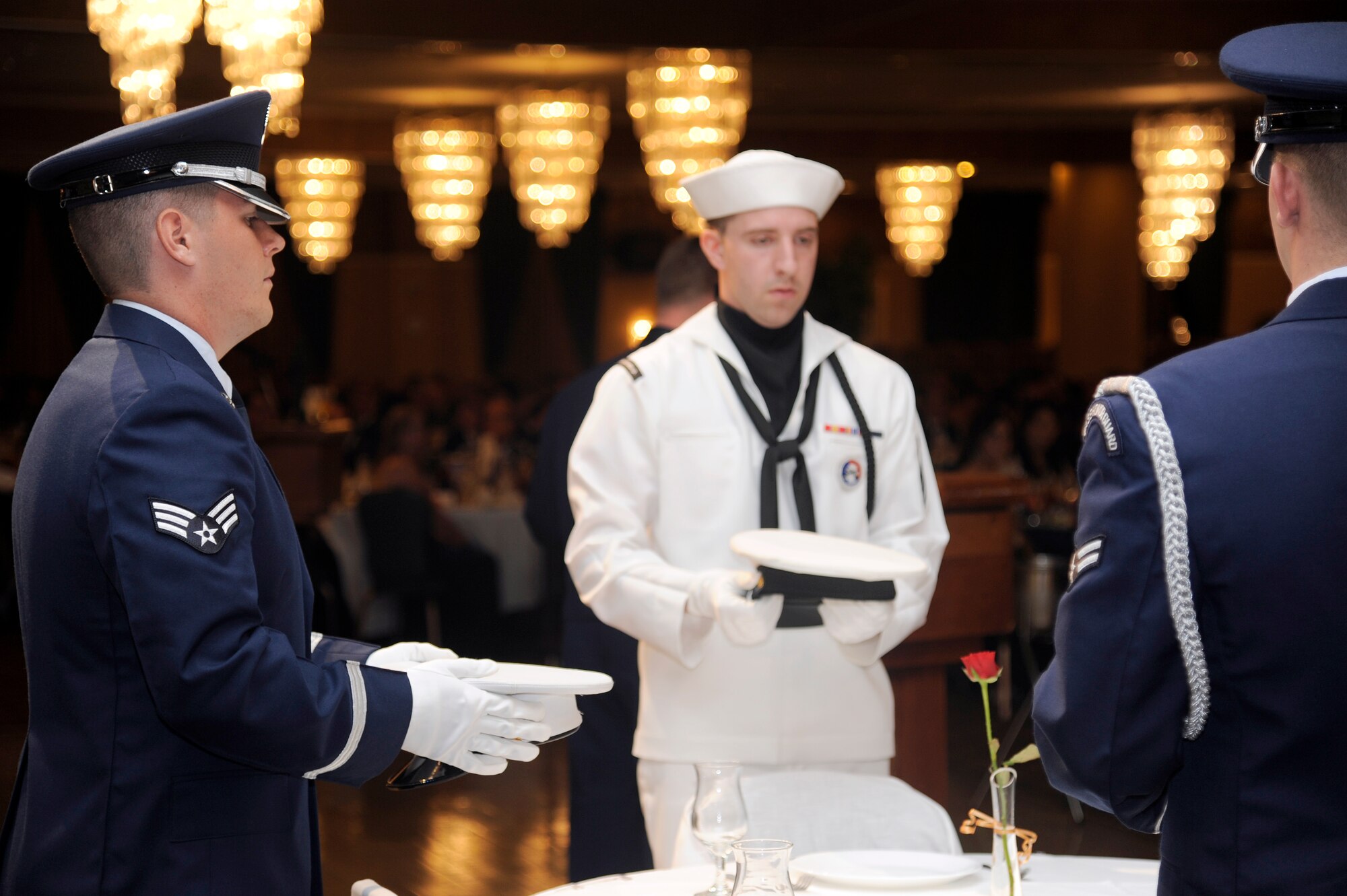 MISAWA AIR BASE, Japan - Members of the Misawa Air Base honor guard present the POW/MIA table during the annual Air Force Ball here Sept. 17. The table is set to recognize and pay tribute to those fellow Airmen, Soldiers, Sailors and Marines who are still missing in action. This year marks the 64th anniversary of the U.S. Air Force. (U.S. Air Force photo/Tech. Sgt. Marie Brown)