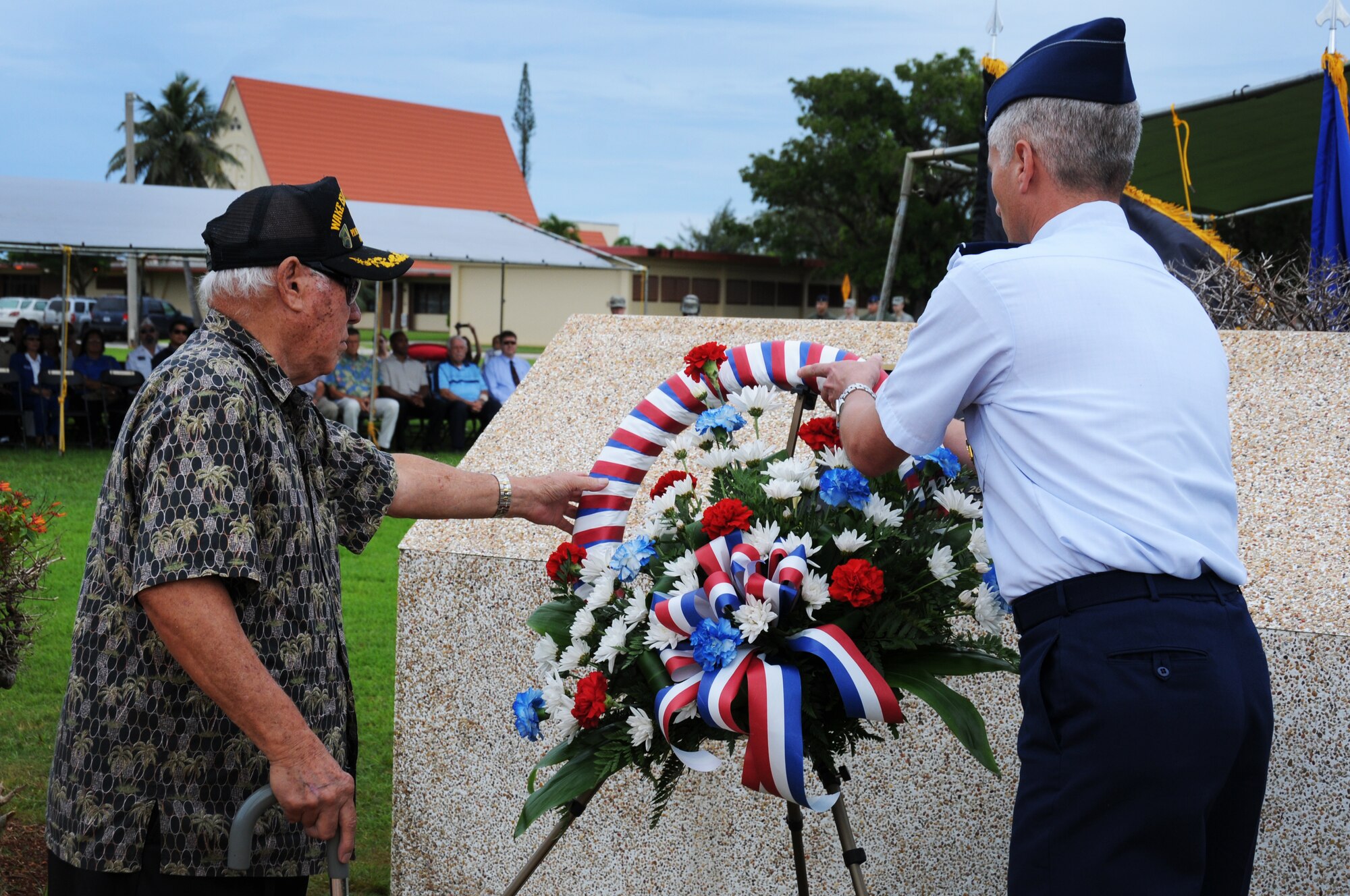ANDERSEN AIR FORCE BASE, Guam – Col. Donald R. Drechsler, 36th Wing vice commander and honored guest, Mr. Francisco Carbullido, a World War II Prisoner of War, place a wreath at the base of the Andersen Air Force Base memorial honoring all those who have fallen, Sept. 16. Mr. Carbullido was taken as a POW and spent 3.5 years in Japanese and Chinese prison camps before returning to Guam.  As the last surviving World War II Wake Island defender, he has received special recognition from Congress. (U.S. Air Force photo/ Senior Airman Carlin Leslie)