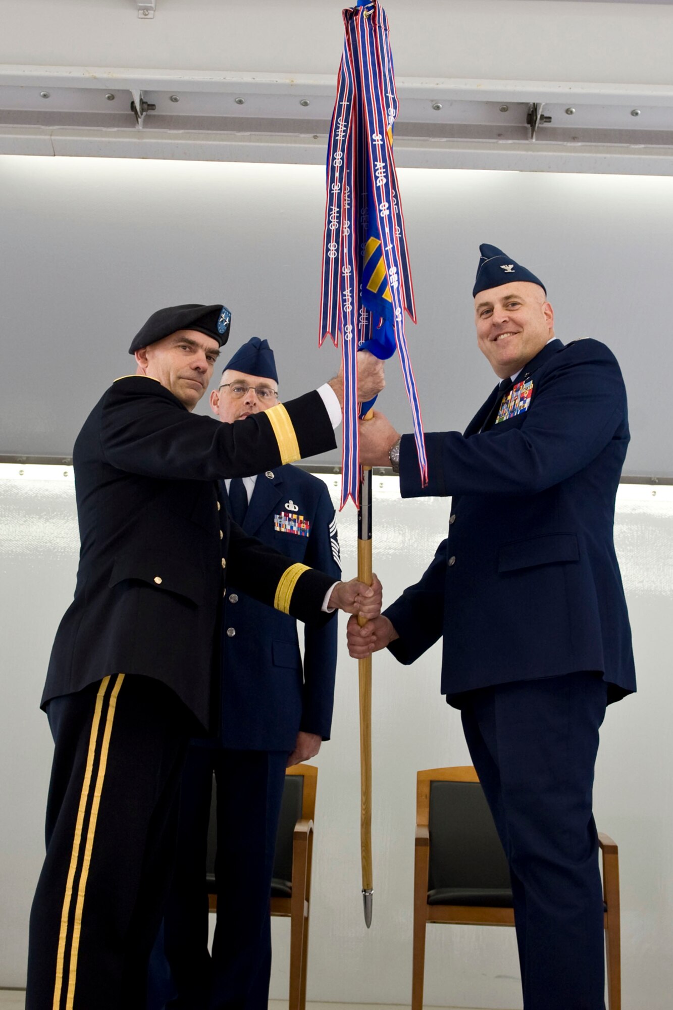 JOINT BASE ELMENDORF-RICHARDSON, Alaska - Col. Donald S. Wenke, the new commander of the 176th Wing, Alaska Air National Guard, accepts the wing guidon from Maj. Gen. Thomas H. Katkus, commander of the Alaska National Guard, during the wing's change of command ceremony Sept. 18, 2011. Wenke assumed command of the wing from Brig. Gen. Charles E. Foster, who has served as the wing commander since 2008. Alaska Air National Guard photo by Master Shannon Oleson.