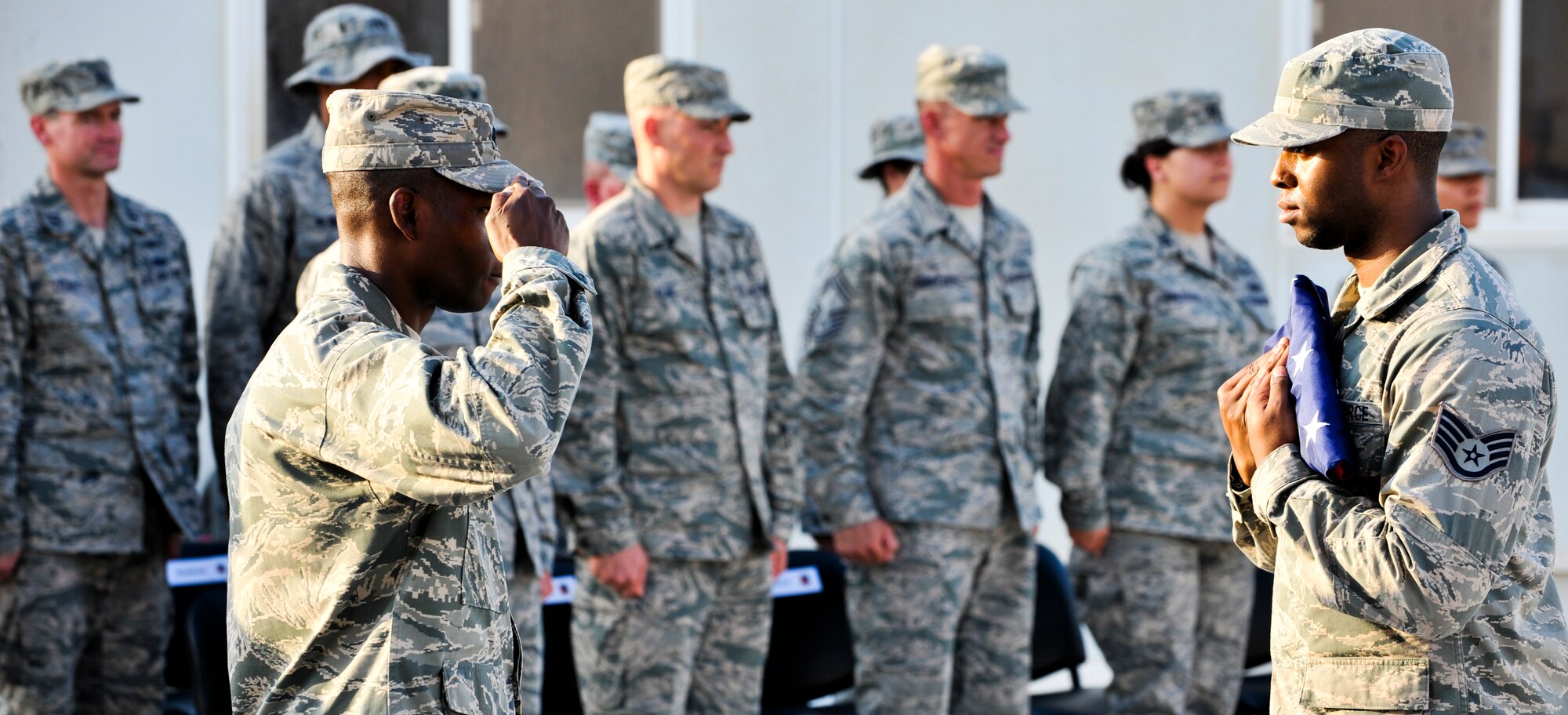 Lt. Col. Terrence Adams, 379th Expeditionary Communications Squadron commander, salutes the American flag during a retreat ceremony, Sept. 16, 2011, at an undisclosed location in Southwest Asia. The retreat marked the final event of Cyber Awareness Week, Sept. 11-16. The week was developed to increase awareness among the base population regarding cyber threats and hackers and to educate individuals about personal responsibilities, such as risk mitigation at work and home. Adams is a native of Tuskegee, Ala. (U.S. Air Force photo/Senior Airman Paul Labbe)