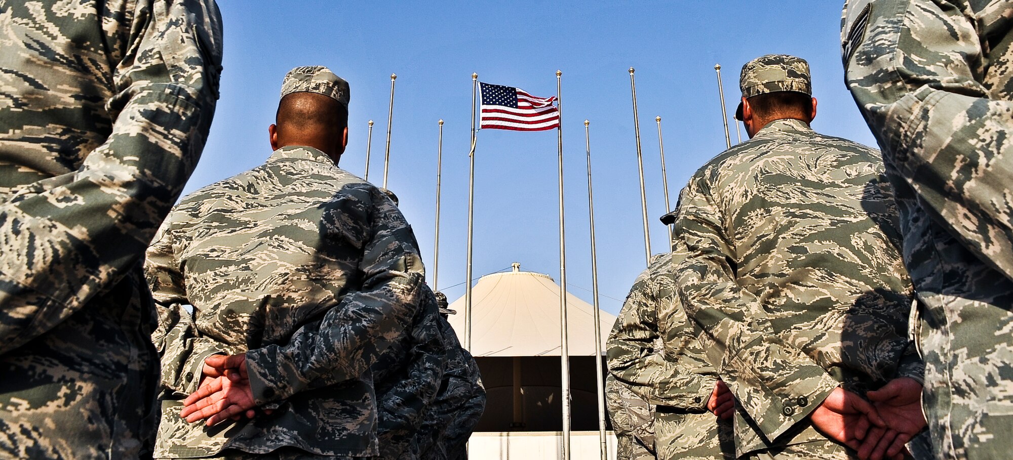 Airmen from the 379th Expeditionary Communications Squadron stand at parade rest before the beginning of a retreat ceremony, Sept. 16, 2011, at an undisclosed location in Southwest Asia. The retreat marked the final event of Cyber Awareness Week, Sept. 11-16. The week was developed to increase awareness among the base population regarding cyber threats and hackers and to educate servicemembers about personal responsibilities, such as risk mitigation at work and home.  (U.S. Air Force photo/Senior Airman Paul Labbe)