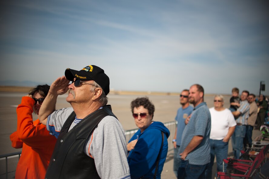 George Alton, an Army veteran of the 101st, salutes during the National Anthem as he enjoys the 2011 Gunfighter Skies air show, on September 17, as Mountain Home Air Force Base opened for a 2-day open house giving visitors a chance to experience a variety of military aircraft, both on the ground and in the air. (U.S. Air Force by Staff Sgt. Robert Barney)