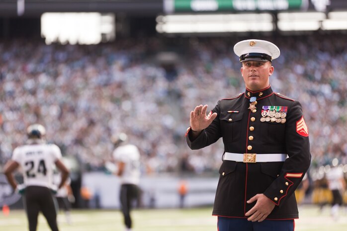 EAST RUTHERFORD, N.J. --  Sgt. Dakota Meyer, stands on the field while his Medal of Honor citation is read during a television time out in the New York Jets vs Jacksonville Jaguars game, at Metlife Stadium, here, Sept 18. Meyer is the only living Marine to be awarded the Medal of Honor for actions since Vietnam. In 2009, he made multiple trips into an intense firefight to try and save members of his team. Meyer recently announced a campaign to He has also issued a "Challenge to America" to match his efforts and raise an additional $1 million to "Honor Marines by Educating their Children."  This challenge allows Americans to help wounded Marines from all conflicts, especially the past 10 years, and forever change their lives by investing in a Marine student's future. For more information visit, www.dakotameyer.com.  (Official Marine Corps photo by Sgt. Randall A. Clinton / RELEASED)