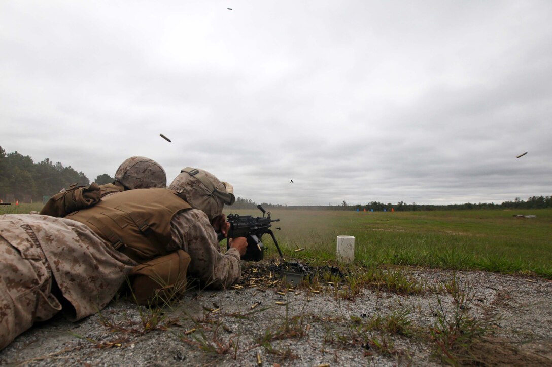 Marines with Combat Logistics Battalion 24, Combat Logistics Regiment 27, 2nd Marine Logistics Group, fire an M249 Squad automatic rifle at range 18, on Fort Pickett, Va., Sept. 18. More than 900 Marines and sailors are taking part in the Deployment for Training exercise at Fort Pickett, Sept. 6-23. The battalion is scheduled to attach to the 24th Marine Expeditionary Unit as its Battalion Landing Team a few days after the training.