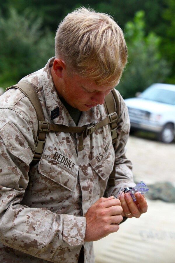 Seaman Derrick Reddick, a hospital corpsman with Combat Logistics Battalion 24, Combat Logistics Regiment 27, 2nd Marine Logistics Group, tests water from a Tactical Water Purification System, on Fort Pickett, Va., Sep. 18, 2011. More than 900 Marines and Sailors are taking part in the Deployment for Training exercise at Fort Pickett, Sept. 6-23. The battalion is scheduled to attach to the 24th Marine Expeditionary Unit as its Battalion Landing Team a few days after the training. (Official USMC Photo by: Lance Cpl. Michael Petersheim/Released)