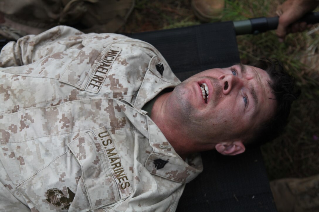 Sgt. Matthew Michaelree, a combat engineer with Combat Logistics Battalion 24, Combat Logistics Regiment 27, 2nd Marine Logistics Group, and St. Louis, Mo., native acts like a simulated casualty hit by an improvised explosive device during an IED lane training exercise on Fort Pickett, Va., Sept. 18, 2011. More than 900 Marines and sailors are taking part in the Deployment for Training exercise at Fort Pickett, Sept. 6-23. The battalion is scheduled to attach to the 24th Marine Expeditionary Unit as its battalion landing team a few days after the training.