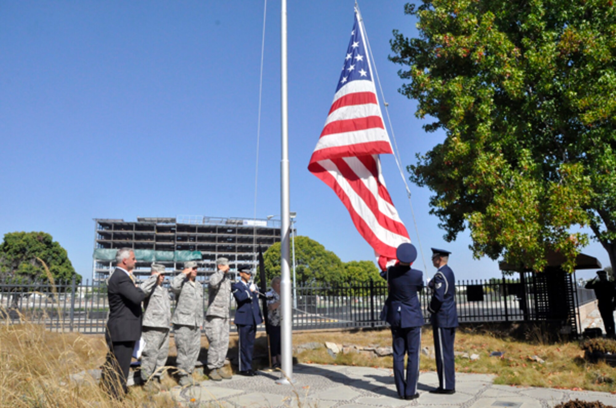 SUNNYVALE, Calif. -Members of the Travis Air Force Base Honor Guard lower the flag during the closing ceremonies at the former Onizuka Air Force Station on Thursday, Sept. 15, 2011.