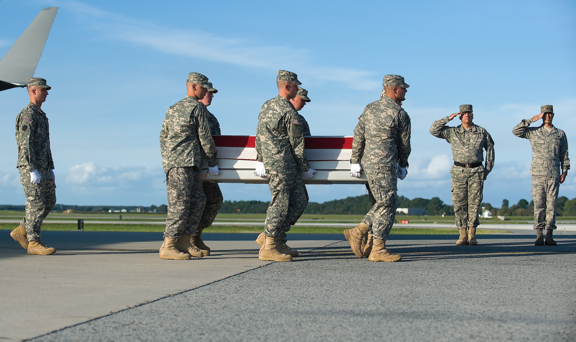 A U.S. Army carry team transfers the remains of Army Spc. Ryan J. Cook, of Ft. Walton Beach, Fla., at Dover Air Force Base, Del., Sept. 19, 2011. Cook was assigned to Company A, 3rd Battalion, 21st Infantry Division, Fort Wainwright, Arkansas(U.S. Air Force photo/Steve Kotecki)
