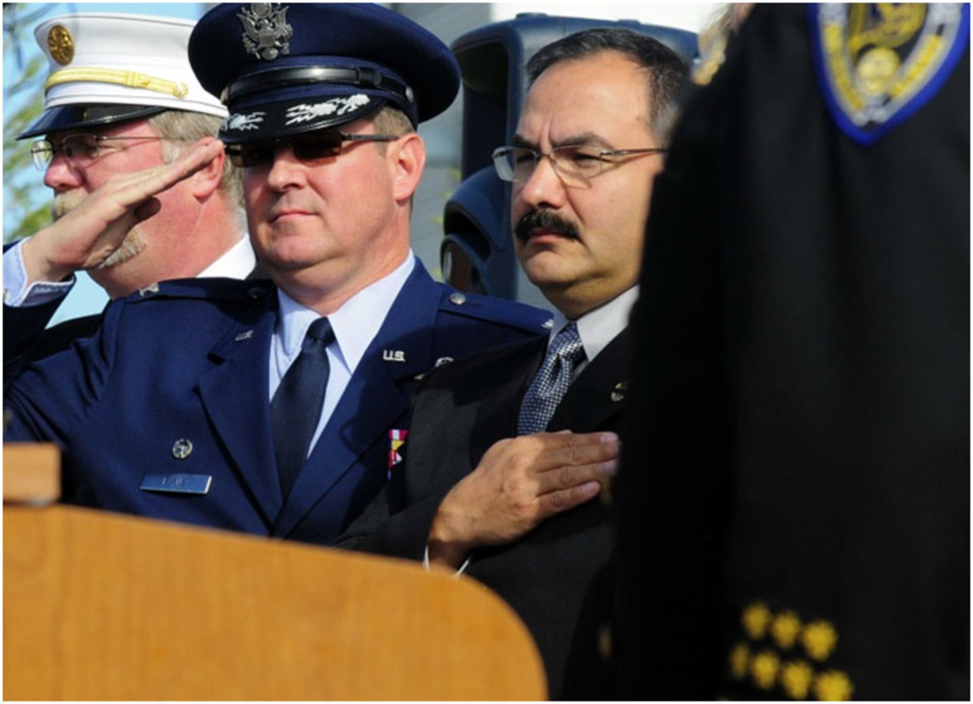 Anchorage -- Col. Robert Evans, 673d Air Base Wing commander, salutes as the National Anthem is played at the start of the 2011 Alaska Fallen Firefighter Memorial Ceremony and 9/11 Remembrance.   (U.S. Air Force photo/Percy Jones)